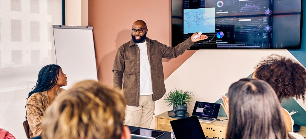man presenting information systems updates to staff